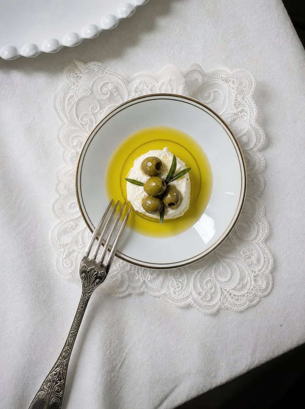 Olives on ricotta in a dish of oil